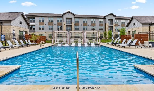 a swimming pool with chairs around it